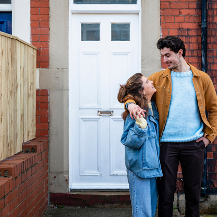 Young Couple Outside New House