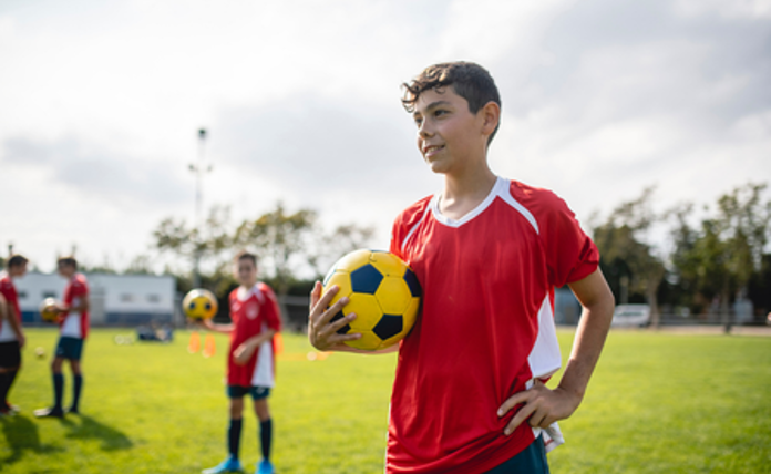 Teenage Boy Holding A Football Landscape