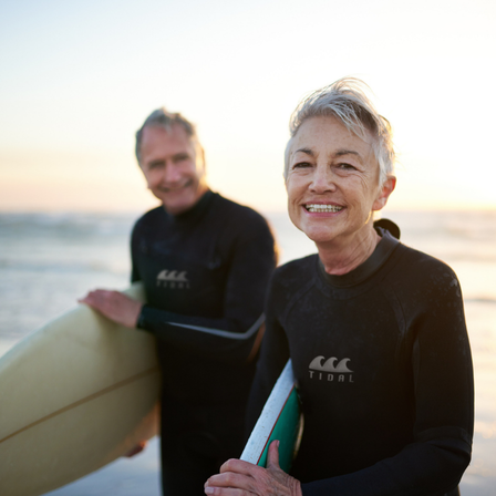 Older-Couple-At-The-Beach-Surfing