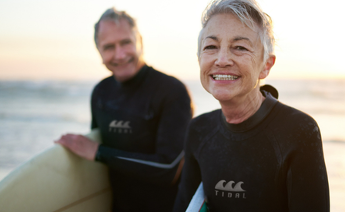 Older-Couple-At-The-Beach-Surfing