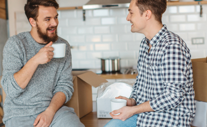 Friends chatting over coffee whilst moving house