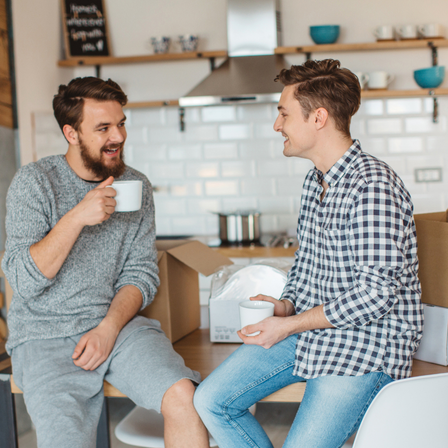 Friends chatting over coffee whilst moving house