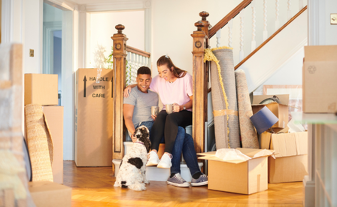 Couple With Dog Moving Into Home Landscape
