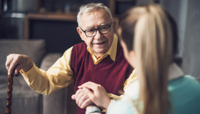 Older Man Being Reassured By Woman Landscape