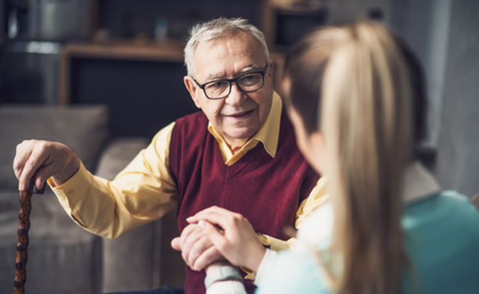 Older Man Being Reassured By Woman Landscape
