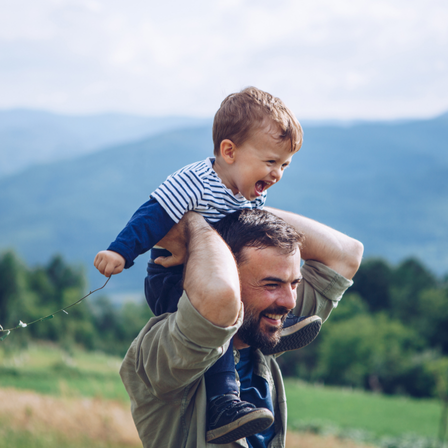 Dad carrying son on his shoulders