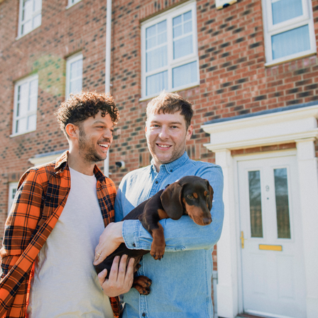 Couple Outside Their New Home