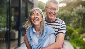 Older Couple Hugging Landscape