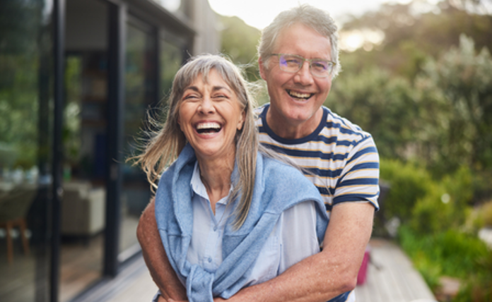 Older Couple Hugging Landscape