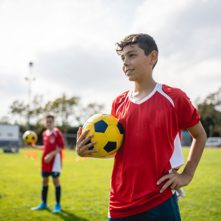 Teenage Boy Holding A Football