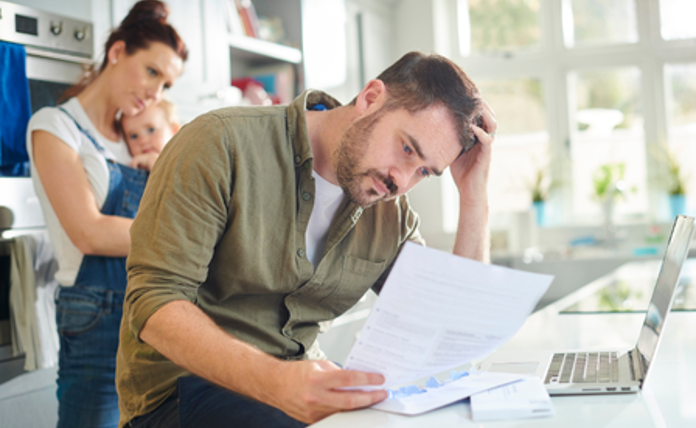 Man Looking Worried At Financial Documents Landscape