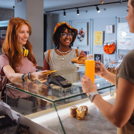 Teenagers buying pastries from a bakery
