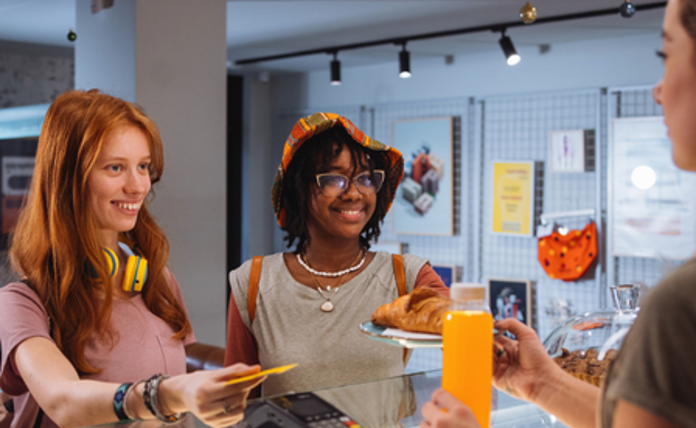 Teenagers buying pastries from a bakery