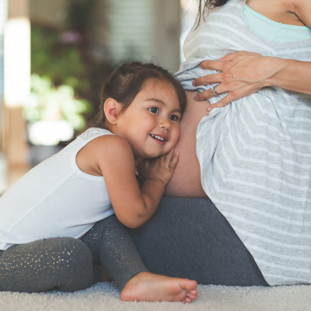 Little Girl Listening To Mum's Belly