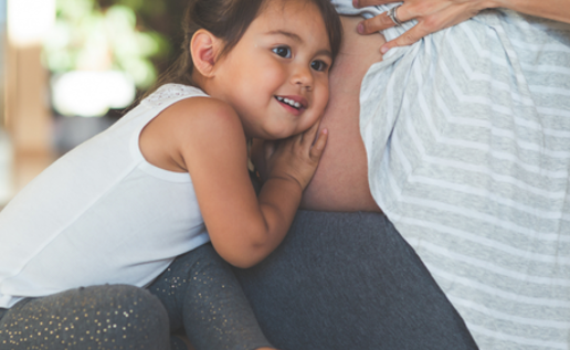 Little Girl Listening To Mum's Belly