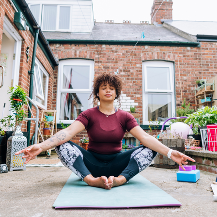 Woman Doing Yoga Outside in her garden