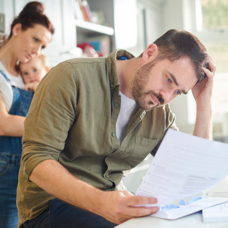 Man Looking Worried At Financial Documents