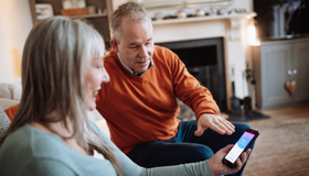 Older couple looking at phone landscape