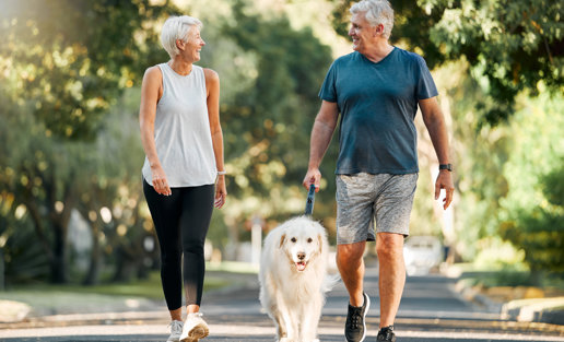 Mature Couple Walking Dog