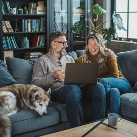 Couple On Sofa With Dog