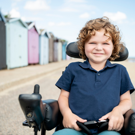 Little Boy Wheelchair By The Beach