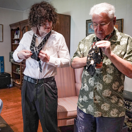 Grandson And Grandad Learning To Tie A Tie
