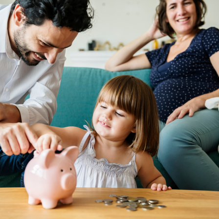 Family With Child And Piggybank