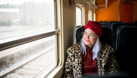 Woman In A Red Turban On A Train Landscape
