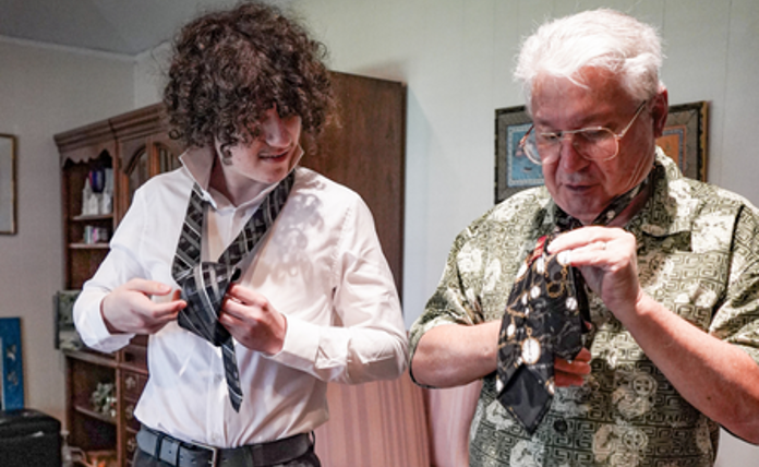 Grandson And Grandad Learning To Tie A Tie