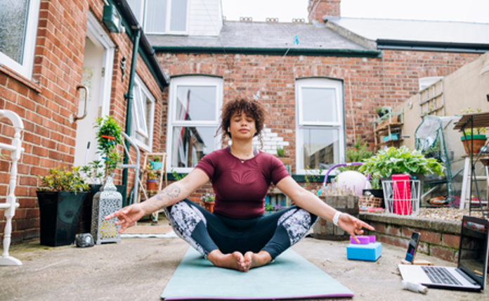 Woman doing yoga outside in her garden