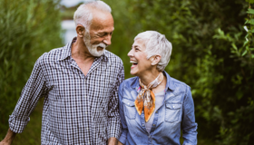 Mature Couple Laughing On Walk Landscape