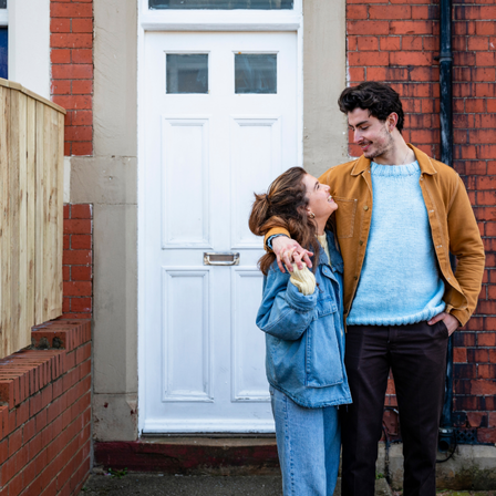 Couple Outside Their New House